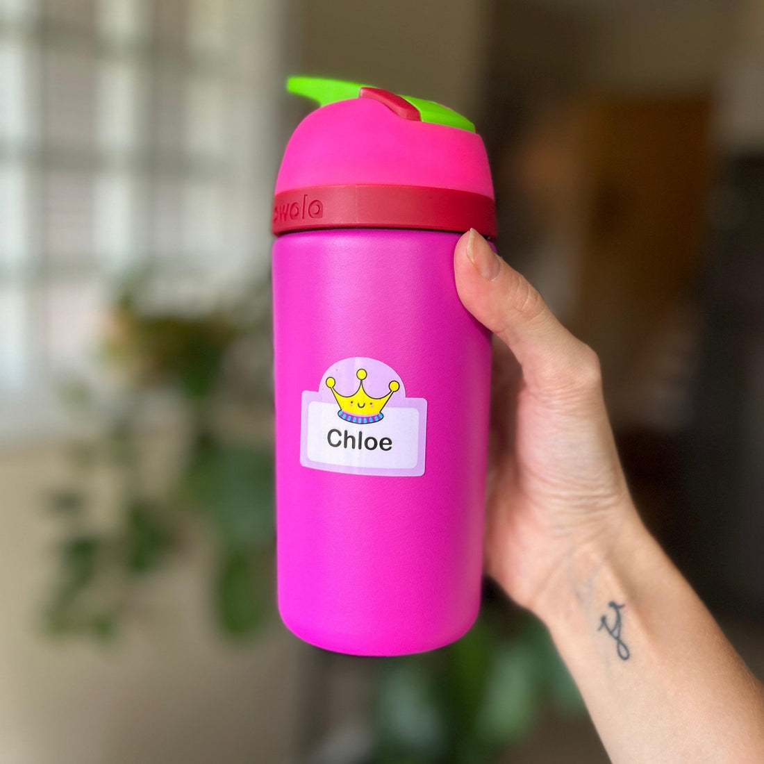 Pink water bottle with a personalized Cherry Tags name label reading Chloe